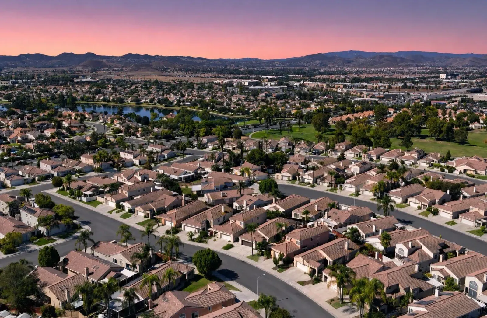Aerial view of a lakeside neighborhood at twilight